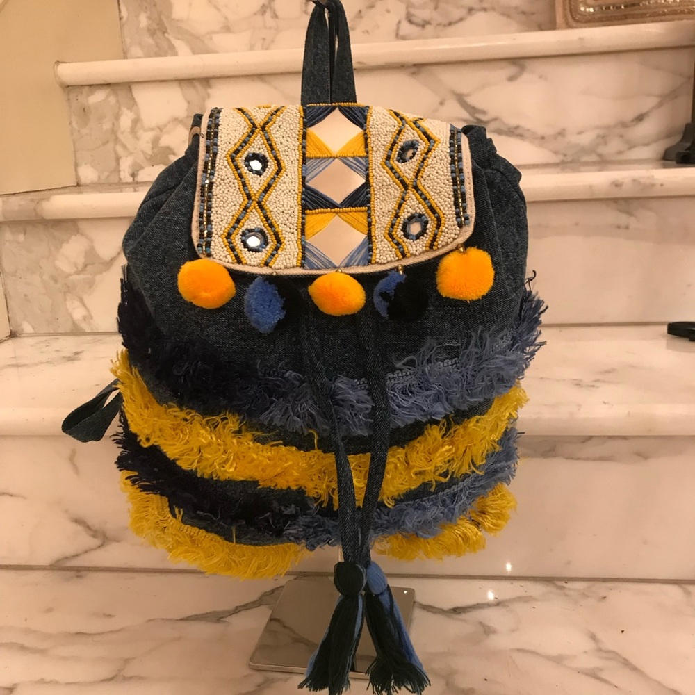Freesia denim pompom & fringed backpack